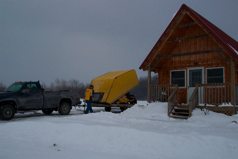 Snowmobile on a snowmobile trailer at one of our cabins.